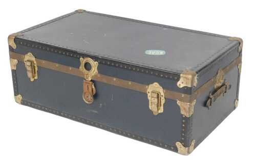 A blue and black canvas trunk, with brass-effect metal corners and leather handles, 92cm wide.