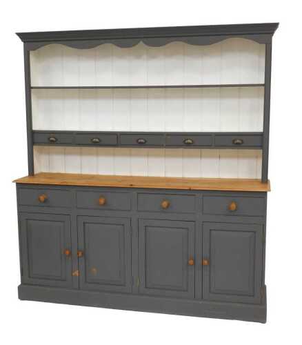 A grey-painted pine dresser, the top with two shelves and five small drawers, the base with four...