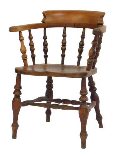 An early 20thC ash and elm smoker's bow chair, stamped Bridge, with spindle-turned supports,...