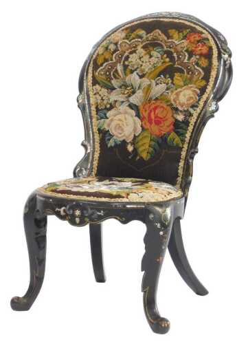 A Victorian papier-m&acirc;ch&eacute; spoonback nursing chair by Jennens and Bettridge, with floral woolwork...