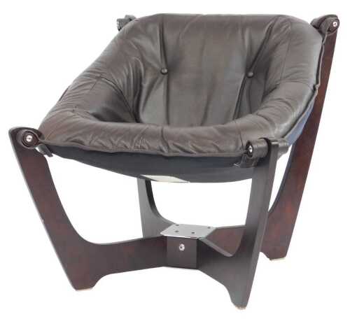 A hardwood and brown leather tub shaped chair in Scandinavian style, with chrome plated mounts,...