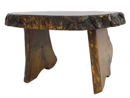 A tree stump coffee table, the oval section of the trunk raised on outswept end supports, 36cm...