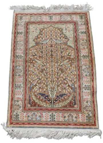 A Persian mercerised cotton prayer rug, decorated centrally with a tree, with flowers and birds,...