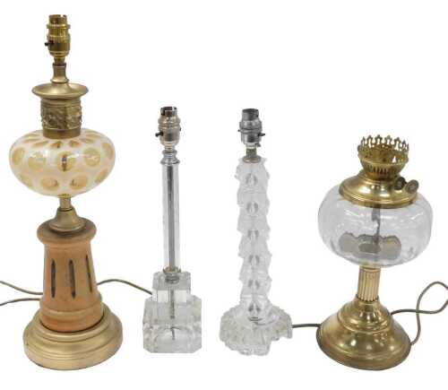 A Continental gilt metal beech and glass table lamp, constructed from various oil lamp and other...