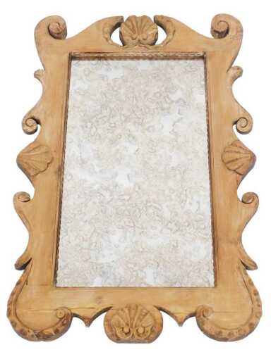 A Georgian style stripped pine wall mirror, carved with shells, 81cm high, 50cm wide.