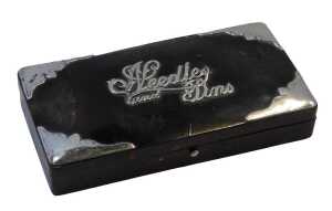 A tortoiseshell and silver-mounted dressing table box, titled Needles & Pins, with hinged lid,...