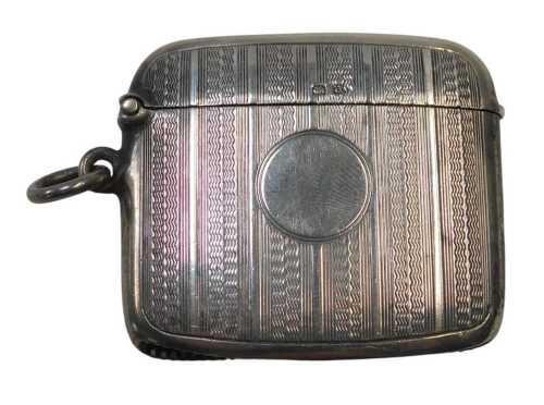 A George V silver Vesta case, with engine-turned decoration and a vacant circular cartouche,...