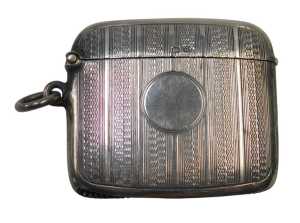 A George V silver Vesta case, with engine-turned decoration and a vacant circular cartouche,...