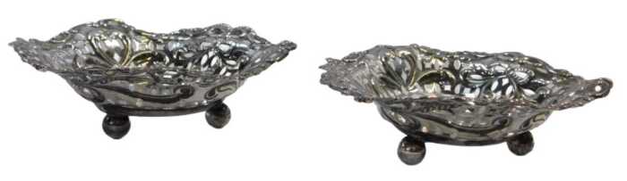 A pair of Victorian pierced silver heart shaped sweetmeat dishes, decorated with bows, flower...
