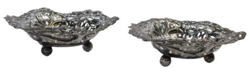 A pair of Victorian pierced silver heart shaped sweetmeat dishes, decorated with bows, flower...