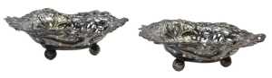 A pair of Victorian pierced silver heart shaped sweetmeat dishes, decorated with bows, flower...