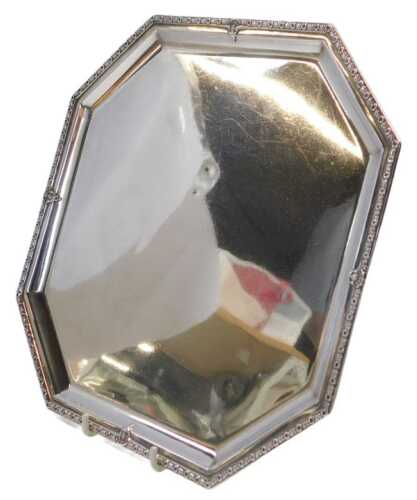 A George V silver salver, of square canted form, the border decorated with flower head and...