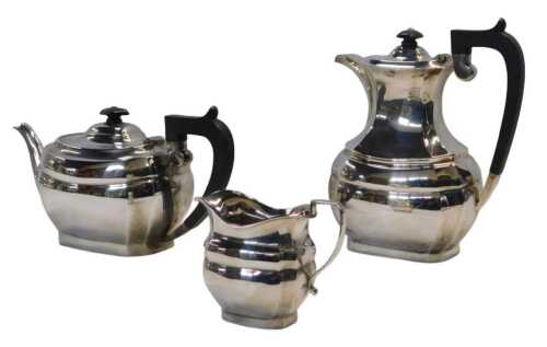 An Elizabeth II three piece tea service, comprising teapot, hot water jug, and milk jug, of semi...
