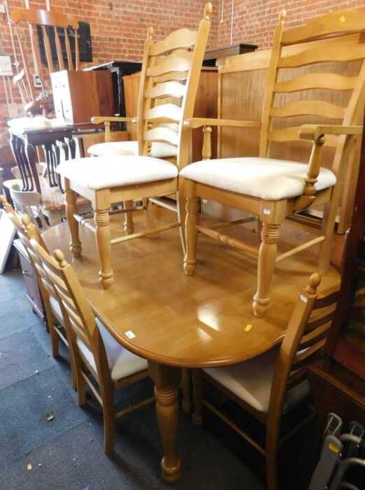 A dining suite, comprising a light wood extending dining table and six chairs, including two...