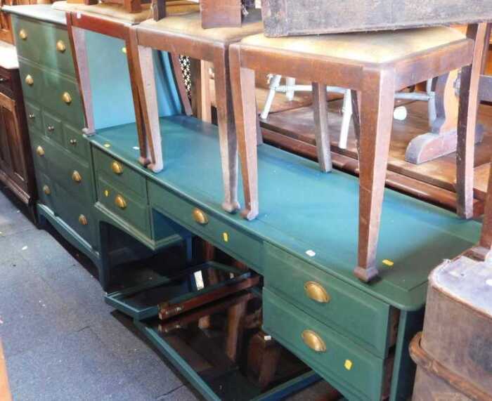 A green-painted chest of seven drawers, raised on bracket supports, 112cm high, 82cm wide, 47cm...