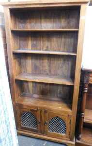 An Indian hardwood bookcase, with cupboard doors below, three shelves over two doors, 190cm high,...