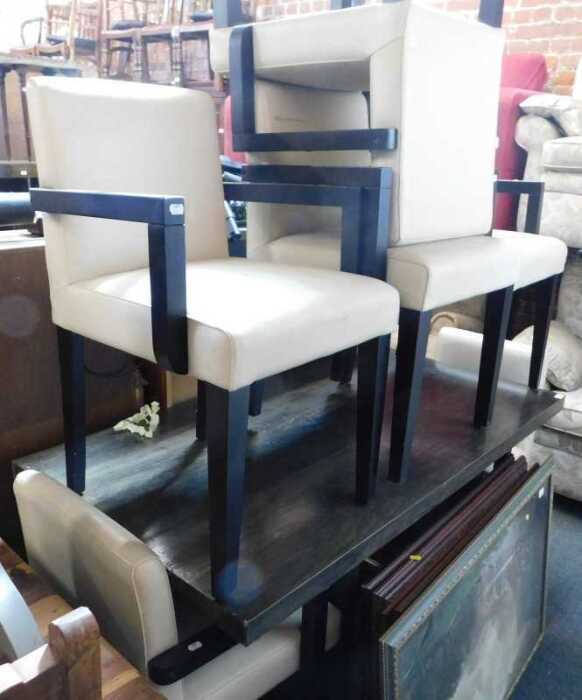 A modern dining suite, comprising a dining table, with a wood effect top, raised on black square...