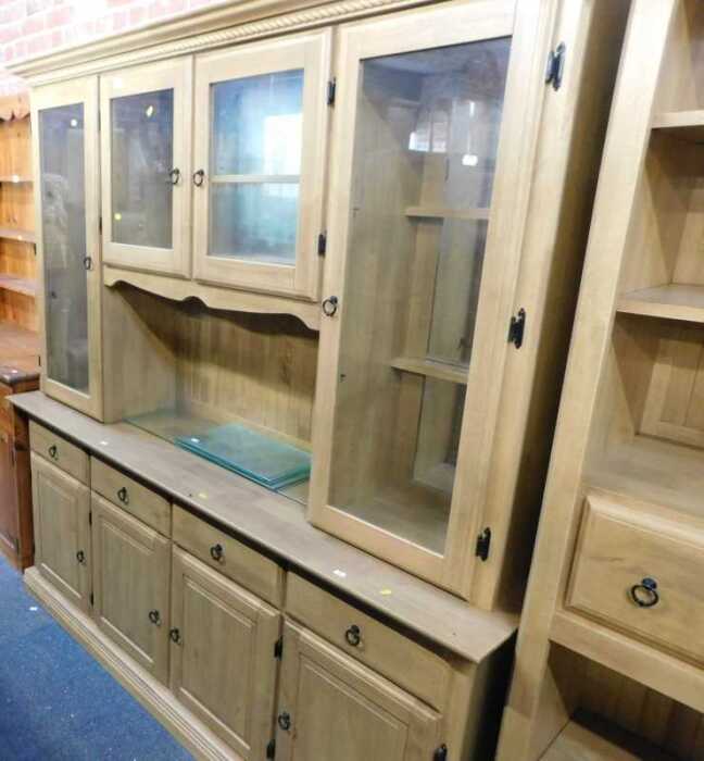 A large lightwood finish dresser, with cornice over two central small glazed doors with shelves...