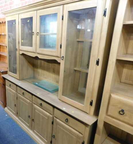 A large lightwood finish dresser, with cornice over two central small glazed doors with shelves...