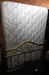 A double bed, with mattress, divan base, split into two with drawers, and a brass headboard.
