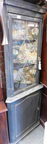 A black finished corner cupboard, with astragal glazed glass door, shelves to interior, over...
