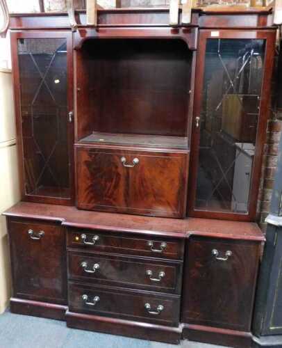 A mahogany veneered display cabinet, with two glazed doors flanked fall front, above base unit...