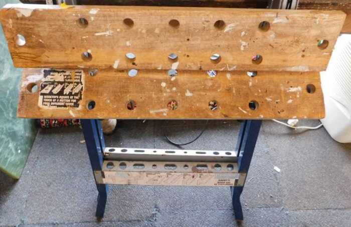 A workmate, with metal frame and wooden top.