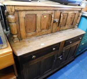 A light elm and beech finished court cupboard, with two doors to top over two drawers above two...