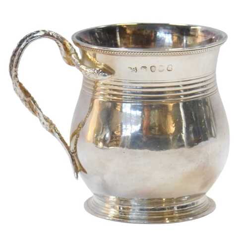 A George III silver mug, with a double entwined serpent handle, and bright cut laurel wreath...