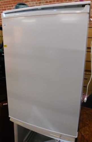 A white finished undercounter freezer.