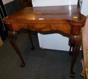 A walnut veneered card table, with lift over top, raised on carved cabriole supports,...