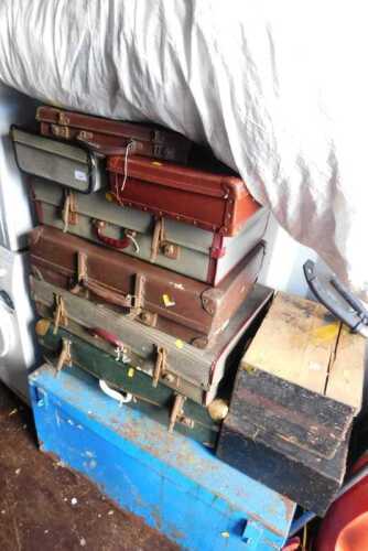 Vintage suitcases and a blue painted trunk.