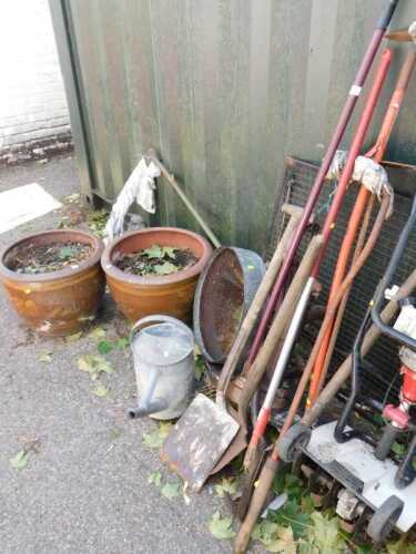 Garden tools, to include a sieve, aluminium watering can, shovels, spades, rakes, hoes, a petrol...