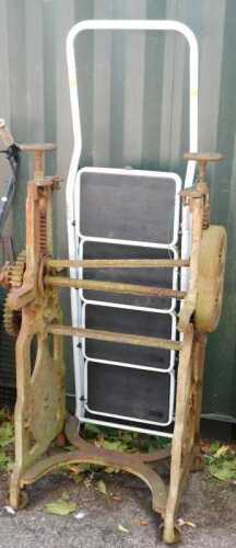 A metal framed mangle, and a set of A frame ladders, finished in white.