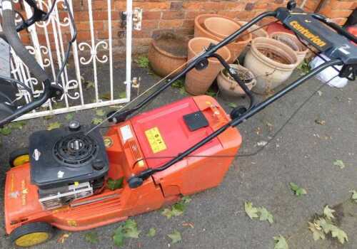 A Wolf Tools petrol lawn mower, with a Briggs and Stratton engine.