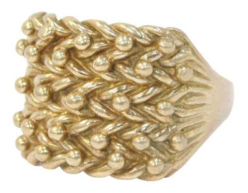 A ball and cross design dress ring, of three layered rows, with a gold plated top and shoulder...