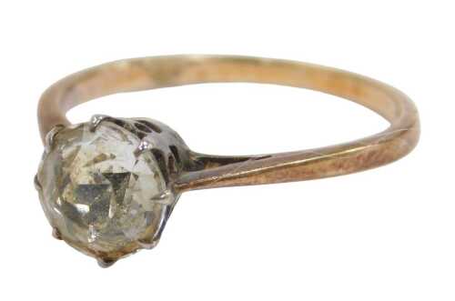 A single stone dress ring, set with imitation diamond, in a raised claw basket white metal...