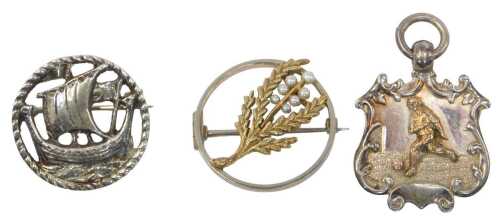 Two brooches and a medallion, comprising a silver football medallion, a Viking boat brooch,...