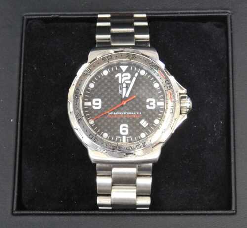 A Tag Heuer Formula 1 wristwatch, the black chequered dial with white batoned pointer and date...