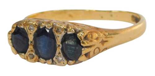 An 18ct gold sapphire and diamond gypsy ring, set with three oval cut sapphires, in a claw...