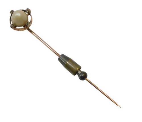 A 20thC stick pin, centred by a cultured pearl and set with four tiny diamond chips, in yellow...