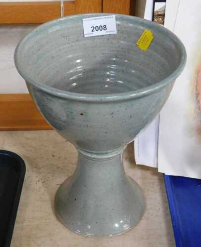 A 20thC studio pottery footed bowl or goblet, in a pale grey glaze, 23cm high.