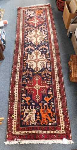 A Caucasian blue ground runner, with four central medallions and stylised beasts within multiple...