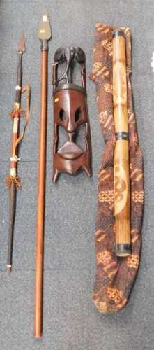 African treen items, to include a large wooden spear, a face mask, another spear, and a small...