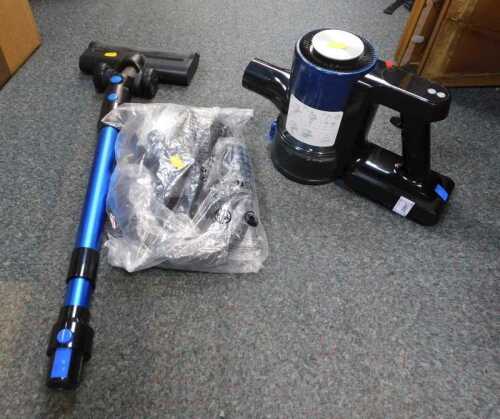 A cordless vacuum cleaner. (under 1 table)