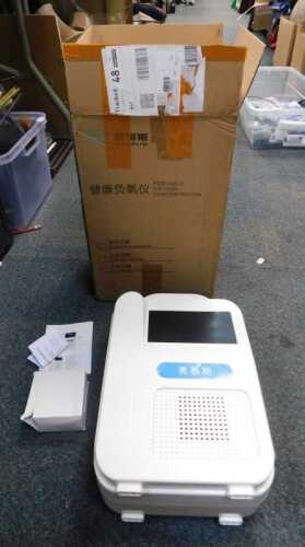 A boxed portable oxygen concentrator, with instructions, etc.