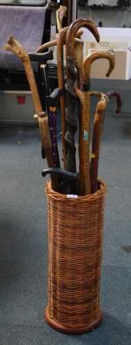 A wicker stick stand, with walking sticks. (13)