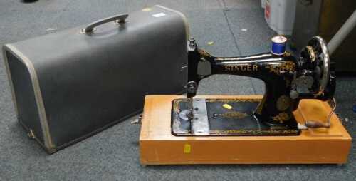 A manual Singer sewing machine, in box.