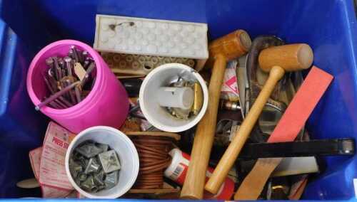 Various leather working tools, including hammers, a leather punch, etc. (1 box under table)