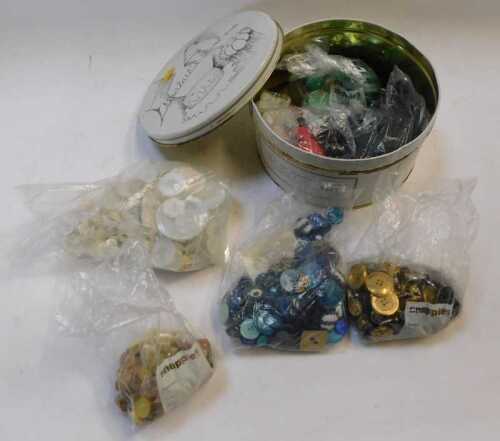 A circular tin, with lid, containing a quantity of buttons, to include mother of pearl.